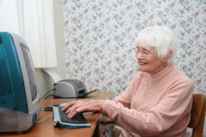 An elderly lady using a computer